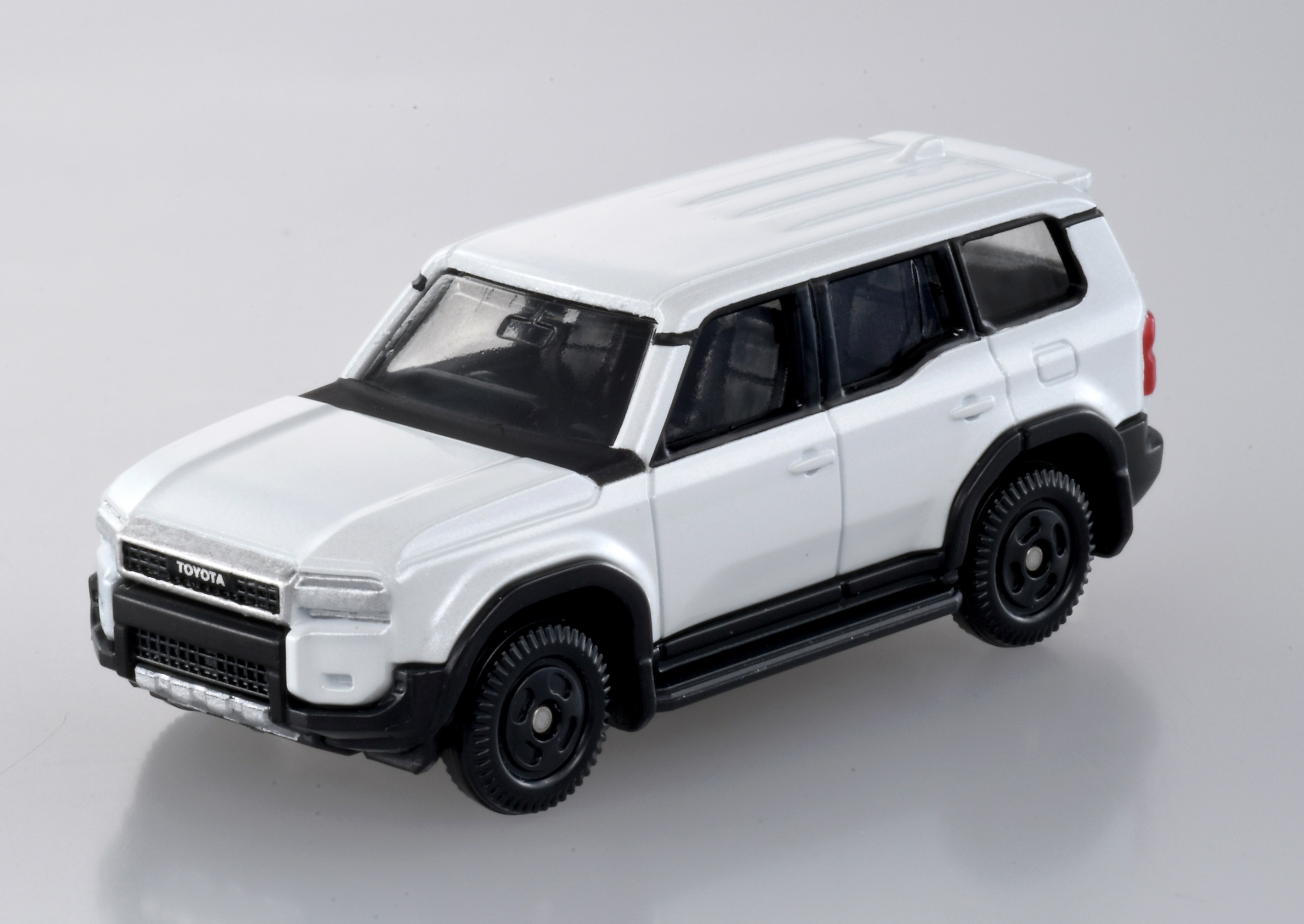 A white car on a boxAI-generated content may be incorrect.